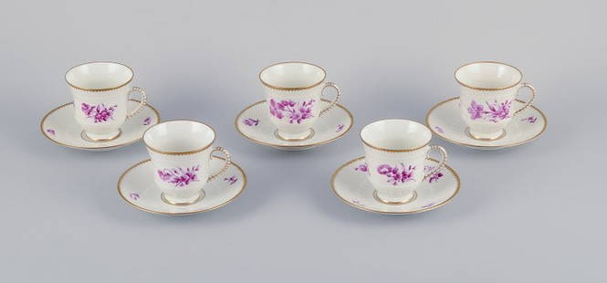 Bing & Grøndahl, Denmark. A set of five coffee cups and saucers with flower decorations in: Bing & Grøndahl, Denmark. A set of five coffee cups and saucers with flower decorations in purple and gold trim. Hand-painted. Approximately 1920s. Marked. In perfect condition. Appears unused. F