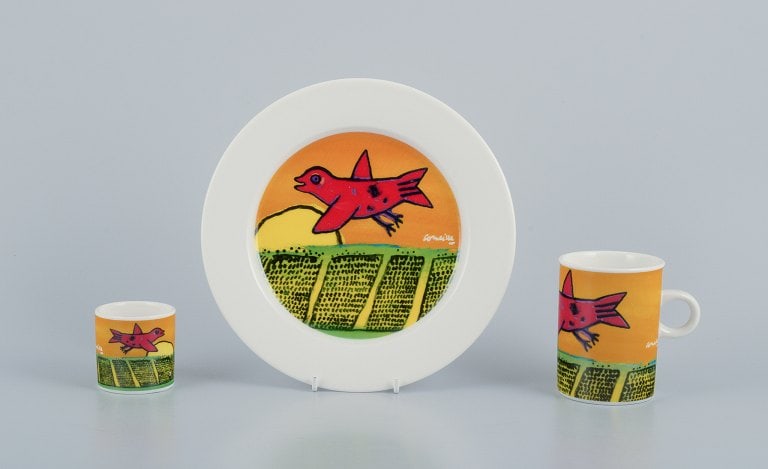 Corneille (Guillaume Cornelis van Beverloo), Dutch CoBrA artist (1922-2010). Coffee cup, plate, and: Corneille (Guillaume Cornelis van Beverloo), Dutch CoBrA artist (1922-2010). Coffee cup, plate, and egg cup in porcelain decorated with birds over a field in sunrise. From the 1980s/90s. In perfect co