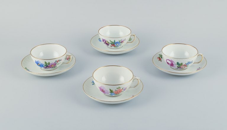 Royal Copenhagen, Saxon Flower, a set of four tea cups with saucers hand-decorated with polychrome: Royal Copenhagen, Saxon Flower, a set of four tea cups with saucers hand-decorated with polychrome flowers and gold rim. Dated: 1941 (3) + 1964 (1). Model numbers: 493-1551. Marked. First factory qual