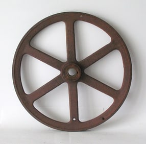 Antique cast iron industrial machinery pulley.