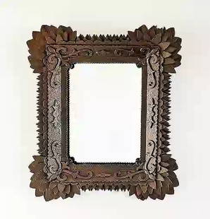 Tramp Art Mirror Frame w Sunflowers by Zubersky: Tramp art frame with sunflower corners and points surround attributed to John Martin Zubersky. The frame exhibits carved decorative flourishes on the top interior layer that is unique to his work. Hea