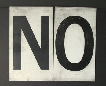 Antique tin movie marque letters “NO”.