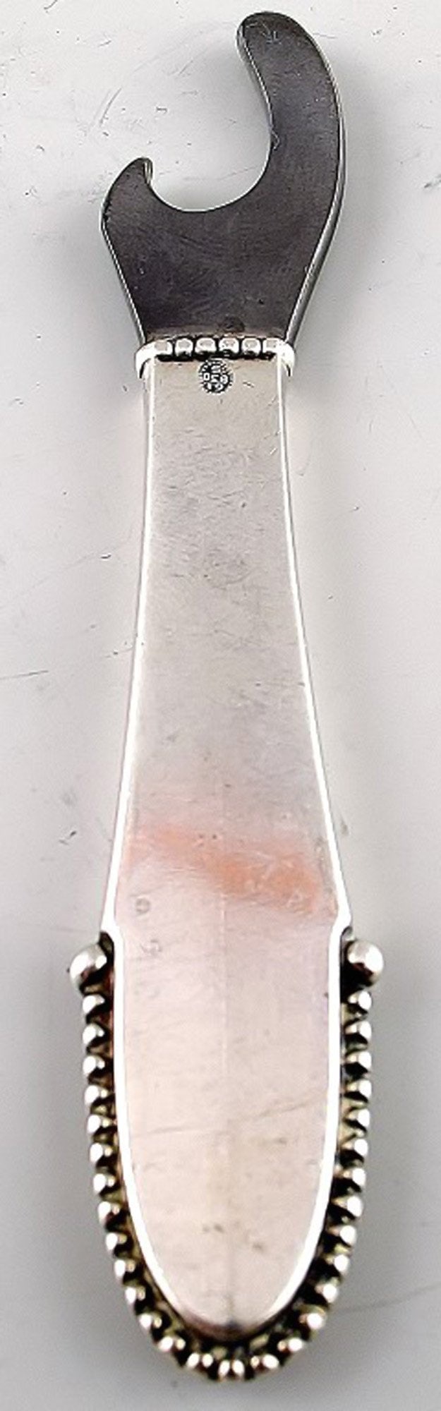 Georg Jensen beaded bottle opener.: Title:Georg Jensen beaded bottle opener. Description:Georg Jensen beaded bottle opener. Measures 10 cm. Marked In good condition. Reserve: $65.00 Shipping: Domestic: Shipping rates are determined by d