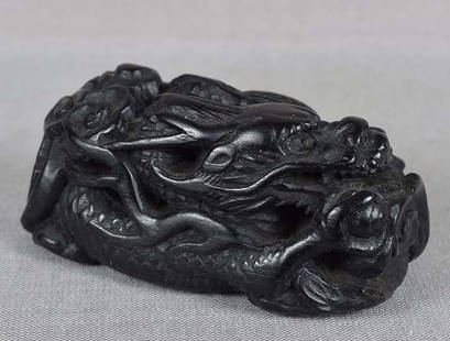 Early 19c ebony netsuke DRAGON with Precious Gem in clouds: Early 19th century kokutan (ebony) netsuke carved as twisting dragon in flight among clouds as it clutches a Tama (Precious Gem) in its front right paw. As any dark object does not photograph well,