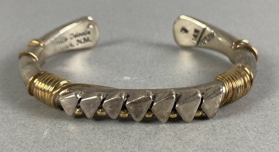 Classy Navajo 14K Gold & Sterling Silver Cuff Bracelet By Orville Tsinnie: The bracelet is in excellent condition. The weight of the piece is shown in the last picture. The bracelet is made of sterling silver with a 14K gold wrapped design. Orville Tsinnie was a master Navaj