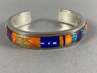 Vibrant Native American Inlaid Stone Cuff Bracelet By Alan Wallace Washoe-Maidu: The bracelet is in excellent condition. The weight of the piece is shown in the last picture. The bracelet is inlaid with stones that appear to be turquoise, lapis, and coral. The artist's hallmark is