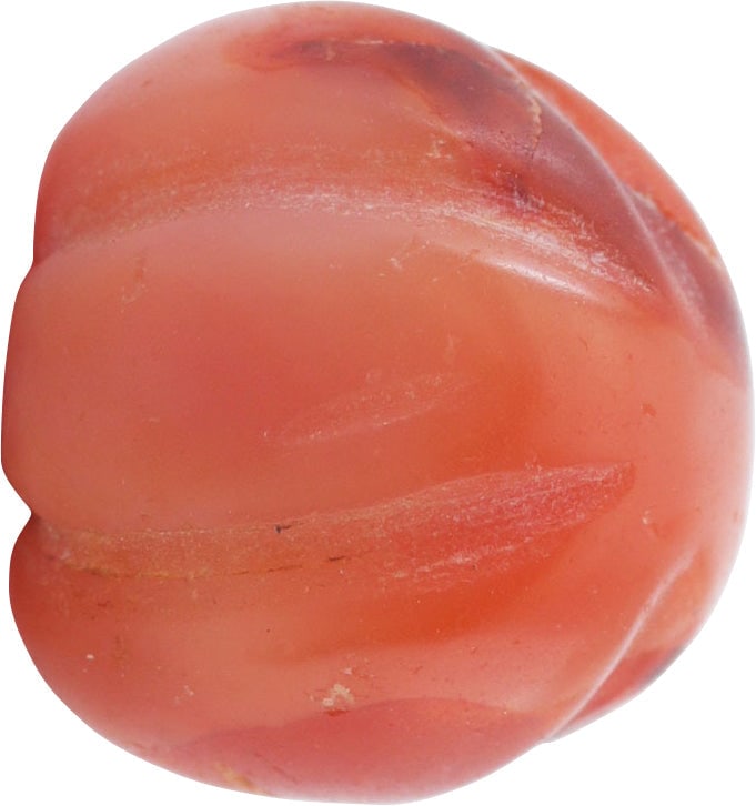 FINE VIKING MELON FORM GEM STONE BEAD 850-1050 AD: Spherical, finely grained carnelian, deeply ribbed to melon form, 0.46” length and 0.53” diameter. Very small conically drilled stringing hole. Probably requires a wire if restrung. Fine p