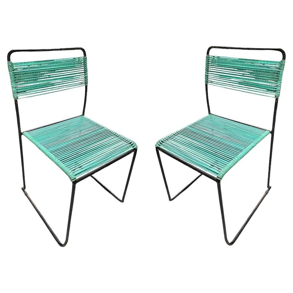 Pair of Walter Lamb Style Iron Blue Corded Outdoor Patio Side Chairs: About the Item A sophisticated set of two outdoor patio chairs in the style of Walter Lamb embodies the sculptural elegance of experimental mid-century design. These chairs feature round tubular iron