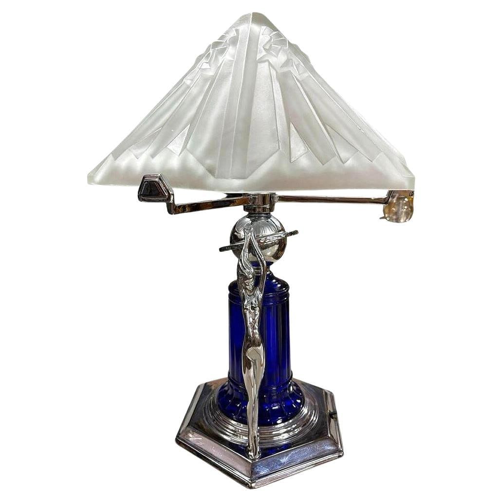 Frankart Era Art Deco Style Chrome & Cobalt Figural Lamp w/ Vivian Glass Shade: About the Item Beautiful Art Deco-style chrome lady lamp with heavy frosted glass shade. there are two female sculptures along the base and a blue cobalt glass light-up shade mounted to a chrome stepp