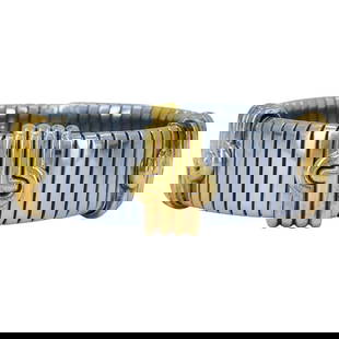 Vintage Bvlgari 18k Gold Steel Tubogas Parentesi Cuff Bracelet: About the Item This vintage Bvlgari Tubogas Parentesi bracelet is crafted from 18k yellow gold and stainless steel. The flexible design features the iconic Parentesi motif in gold across a stretch ste