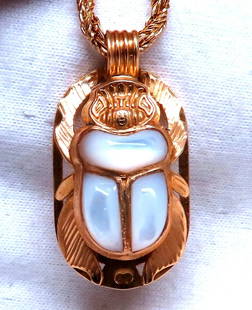 Egyptian Mother of Pearl Specimen Beetle Mother of Pearl Pendant 18kt Necklace: MAGNIFICENT JEWELS Egyptian Iconic Statement Beetle Necklace Carved Mother of pearl Pendant Overall Measurement: 30 x 16mm 23 inch Necklace 18kt. yellow gold Grand weight: 20.7 grams Reserve: $1,440.0