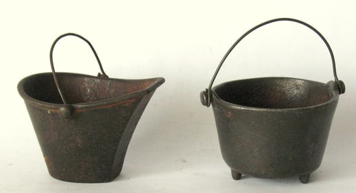 Antique cast iron toy stove pots.