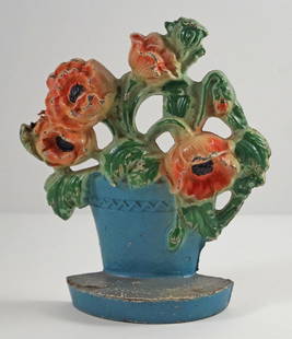 Poppies in Clay Pot Cast Iron Hubley Doorstop: Title: Poppies in Clay Pot Cast Iron Hubley Doorstop Dimension: 7&#8221; tall x 6&#8221; wide. Date: Ca. 1930&#8217;s. Additional Information: Exceptional casting of Poppies in Clay Pot cast iron Anti