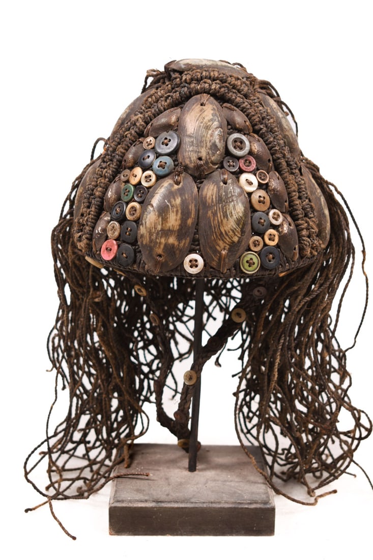 Headdress – Shells, Plant fibre, Buttons – Lega – Congo: Great Bwami headdress from the Lega tribe of DR Congo. These kinds of headdresses were worn by members of the highest ranks of the secret Bwami society, ruling the social structure of the Lega. These 