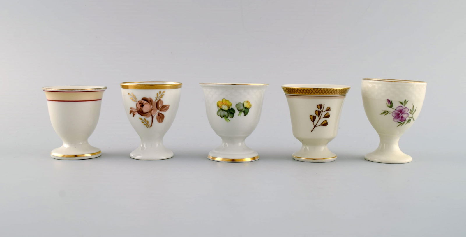 Royal Copenhagen and Bing & Grøndahl. Five egg cups in hand-painted porcelain. 1920s / 30s.: Royal Copenhagen and Bing & Grøndahl. Five egg cups in hand-painted porcelain. 1920s / 30s. Largest measures: 6.7 x 5.2 cm. In excellent condition. Stamped. 1st factory quality. Reserve: $140.00