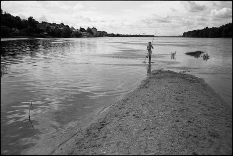 Edition 2/10 - Boy Fishing, Candes Saint Martin, France: Title: Edition 2/10 - Boy Fishing, Candes Saint Martin, France Photograph Artist: Paul Cooklin Origin: United Kingdom Medium: Photography, Black & White on Paper Dimensions: 20 W x 16 H x 0.1 D in Shi