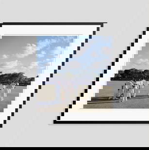 Slim Aarons 'Cricket In Antigua' 1960 C Type Print Framed In Black: Description Slim Aarons 'Cricket in Antigua' 1960 C Type Print Framed In Black Cricketers on the field during a match between the Leeward Islands and the MCC, Antigua, West Indies, 1960. (Photo by Sli