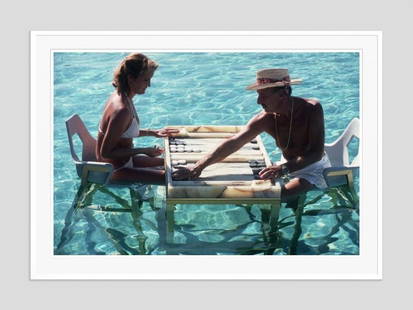 Slim Aarons 'Keep Your Cool' 1978 Oversize White Frame C Type Print: Description Slim Aarons 'Keep Your Cool' 1978 Oversize White Frame c type print Carmen Alvarez enjoying a game of backgammon with Frank &#8216;Brandy&#8217; Brandstetter in a swimming pool at Acapulco