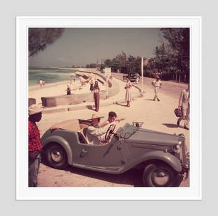 Slim Aarons 'Katharine Hepburn' 1953 Oversize White Frame C Type Print: Description Slim Aarons 'Katharine Hepburn' 1953 Oversize White Frame c type print American film star Katharine Hepburn (1907 &#8211; 2003) driving along the waterfront with Irene Mayer Selznick at Mo