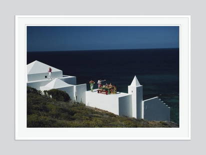 Slim Aarons 'Los Leones' 1990s Giant Oversize C Type Print Framed In White: Description Slim Aarons 'Los Leones' 1990s Giant Oversize C Type Print Framed in White Los Leones, the home of Catherine and Pero Feric at Pointe Milou on the northern coast of Saint-Barthelemy in the