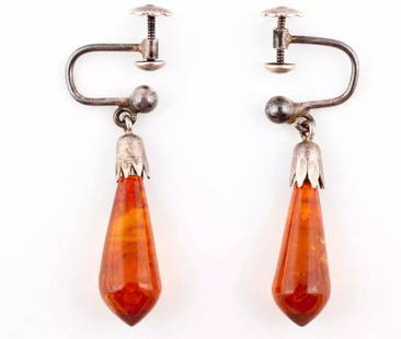 Sterling Silver Carved Amber Dangle Earrings: Title: Sterling Silver Carved Amber Dangle Earrings Description: Sterling silver with amber dangle earrings. Circa 1940?s to 1950?s. Earrings measure 22 mm?s by 7 mm?s. Total weight of 2.3 grams. Scre