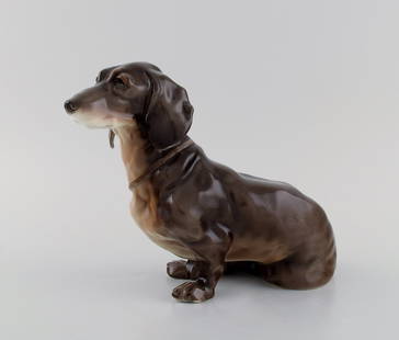 European porcelain maker. Porcelain figure. Seated dachshund. 1930s / 40s.: European porcelain maker. Porcelain figure. Seated dachshund. 1930s / 40s. Measures: 23 x 17 cm. In excellent condition. Stamped. Reserve: $329.00 Shipping: Domestic: Shipping rates are determined by