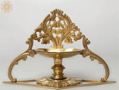 10" Designer Lamp (Diya) with Stand in Brass: Title: 10" Designer Lamp (Diya) with Stand in Brass Description: Brass Height: 6 inch Width: 10 inch Depth: 5 inch Weight: 1.13 kg Additional Information: This beautiful designer brass lamp is general