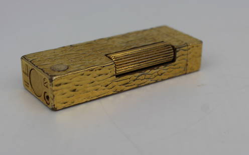Vintage Dunhill Bark Texture Lighter: Vintage Dunhill Swiss-Made Gold-Plated Lighter &#8211; Textured Bark Finish A superb vintage Dunhill lighter, Swiss-made and crafted with a distinctive gold-plated textured bark finish. This elegant a
