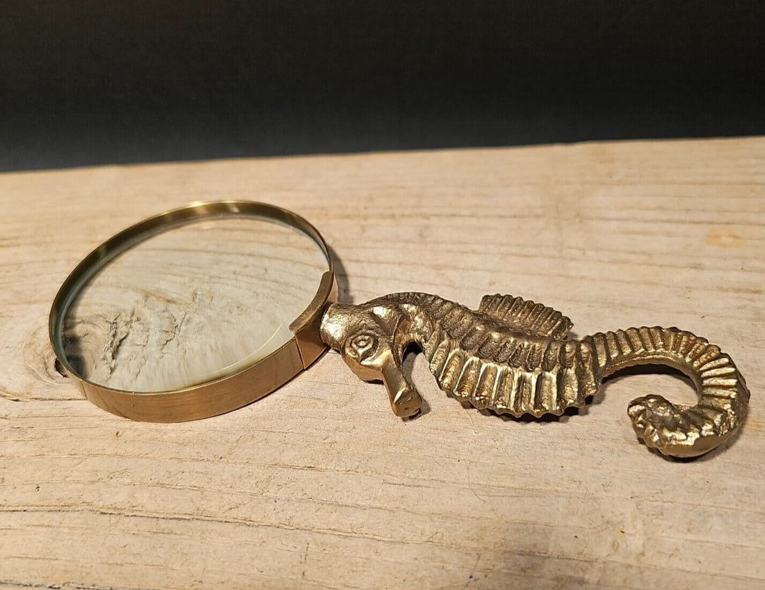 7" Brass Seahorse Magnifying Glass Desk Hand Lens: The 7" long x 3" wide glass reproduction of an antique magnifying glass with a cast brass seahorse handle is a stunning piece that harks back to the 18th and 19th centuries. During this era, magnifyin