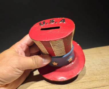 4 1/2" Cast Iron USA Patriotic Hat Coin Bank: 4 1/2" x 4 1/2" Wonderful reproduction Cast Iron USA Patriotic Hat Coin Bank Designed to resemble Uncle Sam's iconic top hat, featuring patriotic red, white, and blue colors with "U.S.A." written on t