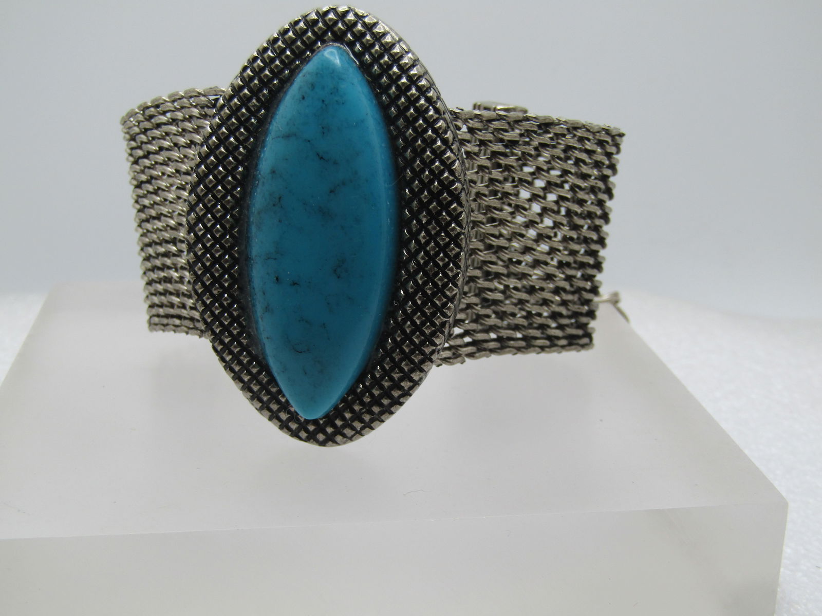 Vintage Faux Turquoise Wide Mesh Bracelet, 7.5"-9.5" Southwestern Themed. 1980's: Vintage Faux Turquoise Wide Mesh Bracelet, 7.5"-9.5". 1980's. The mesh portion of the bracelet is appx. 1.5" wide with a center raised cateye shaped ridged setting that holds a faux turquoise stone. T