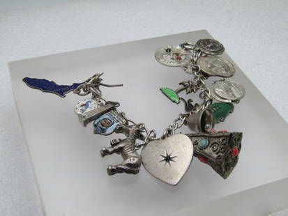 Vintage Sterling Charm Bracelet, 7", 17 Charms, 1960's-1970's: Vintage Sterling Charm Bracelet, 7", 17 Charms, 1960's-1970's. Most of the charms are sterling and are marked - a few are not. Sterling charms: palm tree; blue enameled Florida state charm; Washington
