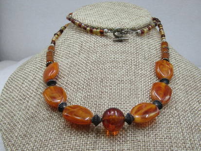 Vintage Amber & Browns Beaded Necklace, 26": Vintage Amber & Browns Beaded Necklace, 26". A mix of amber colored acryliC flat stones that are appx. 3/4" long and 5/8" wide with fluted spacer beads between and then a mix of glass beads: brown, ta