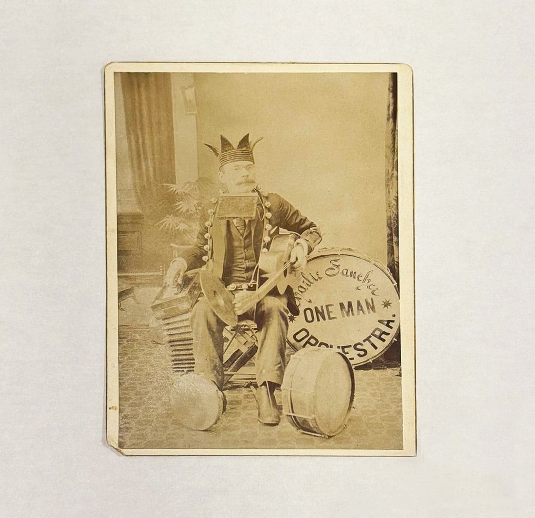 Whimsical Historical Cabinet Card Photo 'One Man Orchestra': Title: Whimsical Historical Cabinet Card Photo 'One Man Orchestra' Description: A whimsical cabinet card photograph from the early 1900s showing a man surrounded by musical instruments and wearing a j