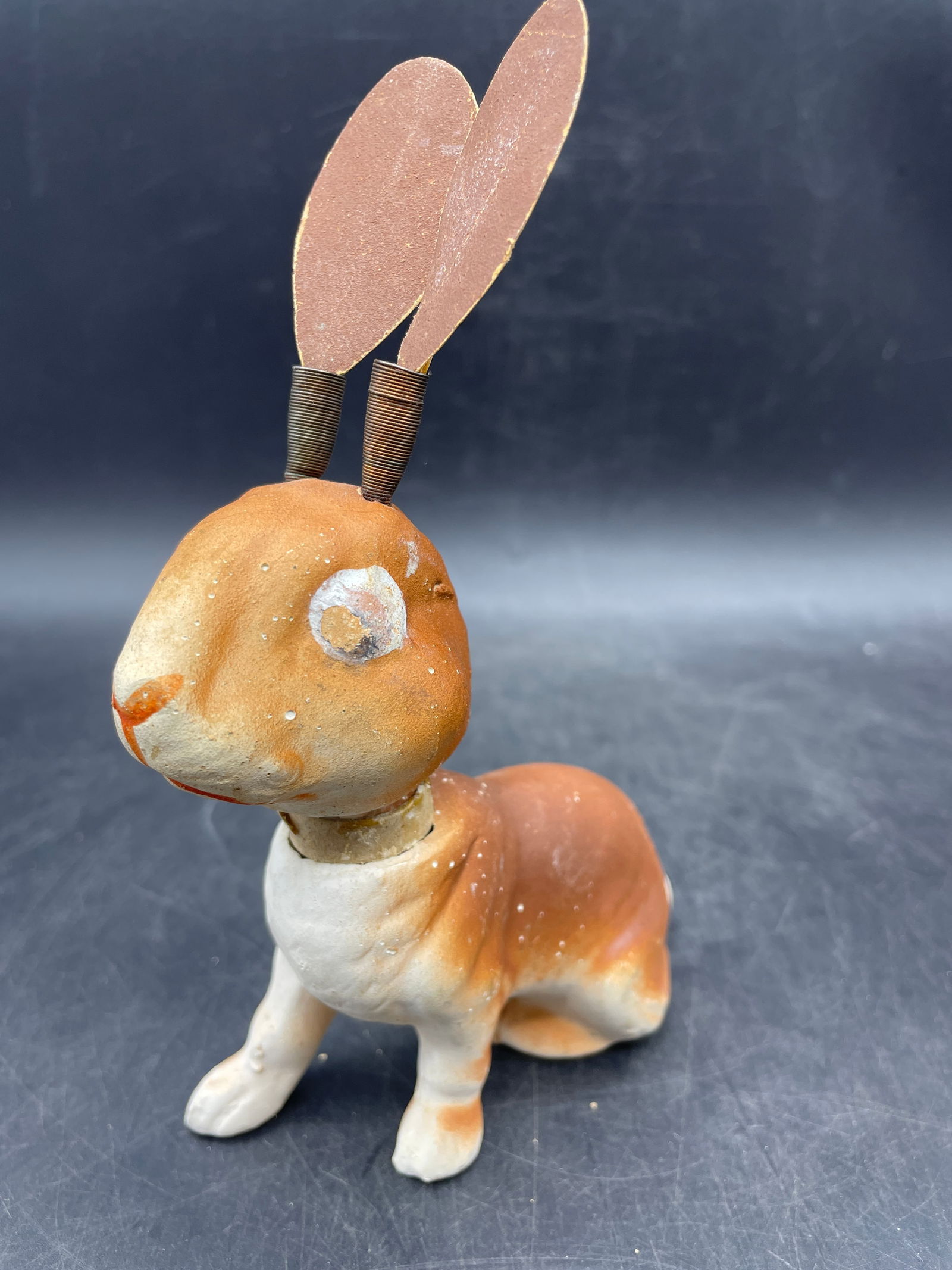 Old EASTER BUNNY RABBIT CANDY CONTAINER W/ WIGGLY EARS-HEAD- W GERMANY: Title: Old EASTER BUNNY RABBIT CANDY CONTAINER W/ WIGGLY EARS-HEAD- W GERMANY Date/Period: approx 1950's Dimension: approx. 6 x 4.5 x 2 Material: bisque, paper, metal Additional Information: Old EASTE
