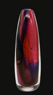 CRYSOPHIS STEVEN HOURIGAN ART GLASS VASE SIGNED: Title: CRYSOPHIS STEVEN HOURIGAN ART GLASS VASE SIGNED Date/Period: UNKNOWN Dimension: 7.5 X 2.5" Material: GLASS Additional Information: PINKS AND BLUES WITH BLACK HOUSE NET PATTERN Provenance: Priva
