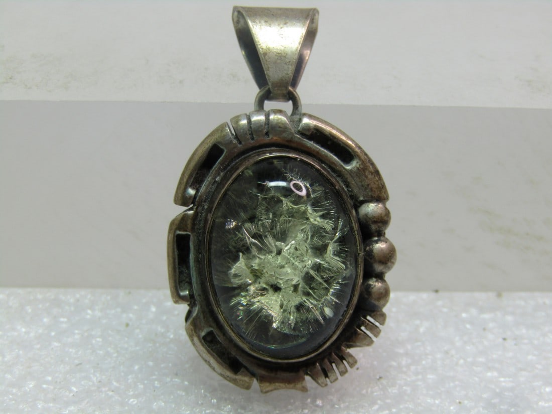 Vintage Sterling Navajo Green Amber Pendant, Signed E. Jackson, 1960's: Vintage Sterling Navajo Green Amber Pendant, Signed E. Jackson, 1960's. This has a swing bail and decorative SIlver beaded and cut frame around the raised bezel-set oval green amber cabochon. It is ve