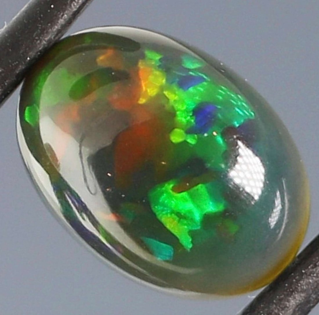 Patchwork patterned 2.38ct Welo Black Opal: Title: Patchwork patterned 2.38ct Welo Black Opal Description: The color of this opal's patchwork pattern is in constant movement, rolling through its body in crisp neon green and ruby red flashing wi