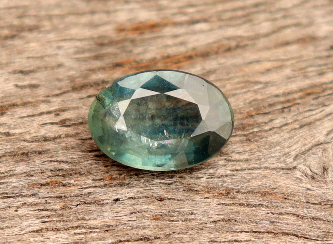 0.84 Carats Natural Sapphire: Title:0.84 Carats Natural Sapphire Additional Info:Gemstone: Natural SapphireCarat Weight: 0.84Shape/Cut: Oval CutMeasurements: 6.97x4.80x2.78 mmColor: Blueish GreenTransparency: TranslucentClarity: T