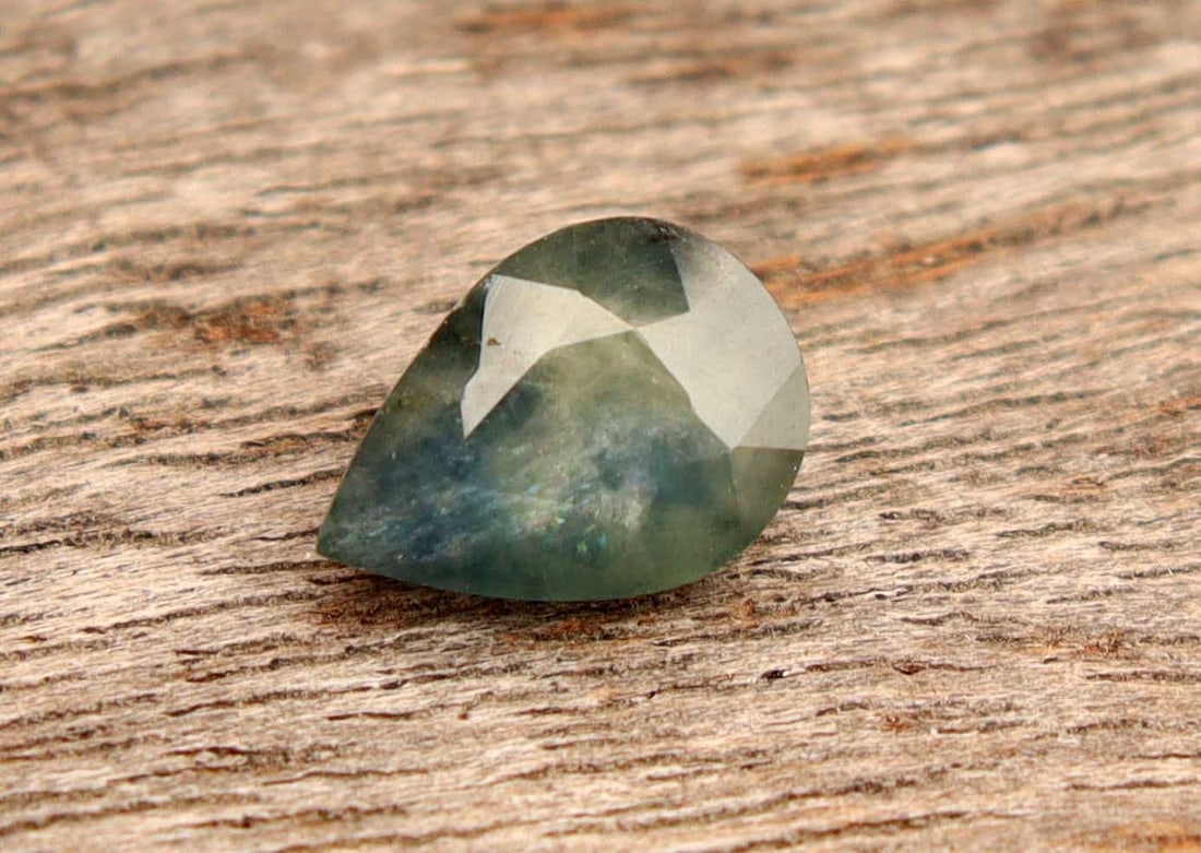 1.33 Carats Natural Sapphire: Title:1.33 Carats Natural Sapphire Additional Info:Gemstone: Natural SapphireCarat Weight: 1.33Shape/Cut: Pear CutMeasurements:7.97x5.71x3.59 mmColor: Blueish GreenTransparency: TranslucentClarity: Th