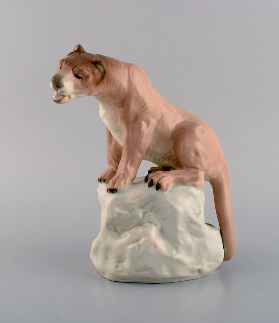 Amphora, Czechoslovakia. Hand painted porcelain figurine of lioness on rock. 1930/40's.: Amphora, Czechoslovakia. Hand painted porcelain figurine of lioness on rock. 1930/40's. Measures: 22 x 17 cm. In excellent condition. Stamped. Reserve: $413.00 Shipping: Domestic: Shipping rates are d