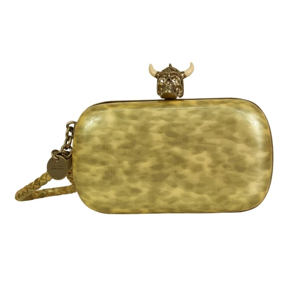 Alexander McQueen Gray Patent Leather Viking Studded Silver Skull Clasp Clutch: Alexander McQueen Gray Patent Leather Viking Studded Silver Skull Clasp Clutch Give into your gilty pleasures with this beige and gray patent leather Viking skull box clutch. This is a chic and stylis