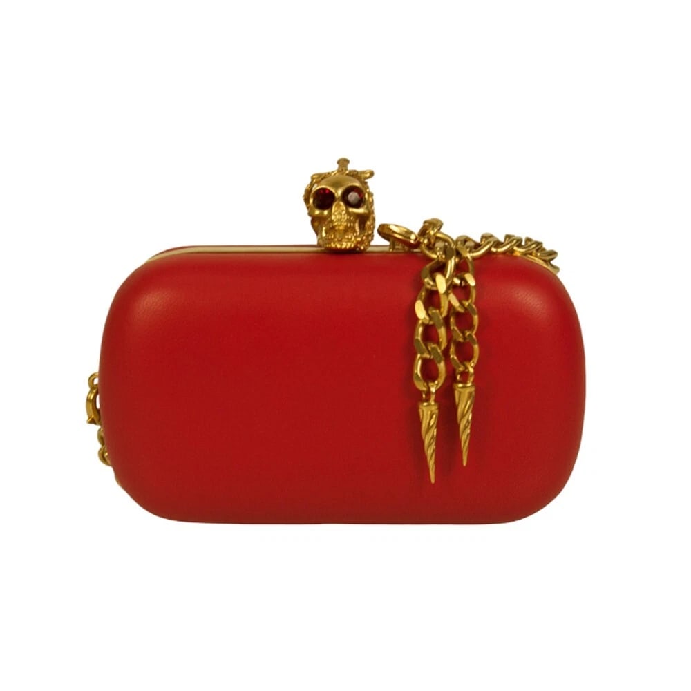 Alexander McQueen Red Leather Crystal Studded Gold Stabbed Skull Clasp Clutch: Alexander McQueen Red Leather Crystal Studded Gold Stabbed Skull Clasp Clutch Give into your gilty pleasures with this bright red leather skull box clutch. This is a chic and stylish clutch bag by Ale