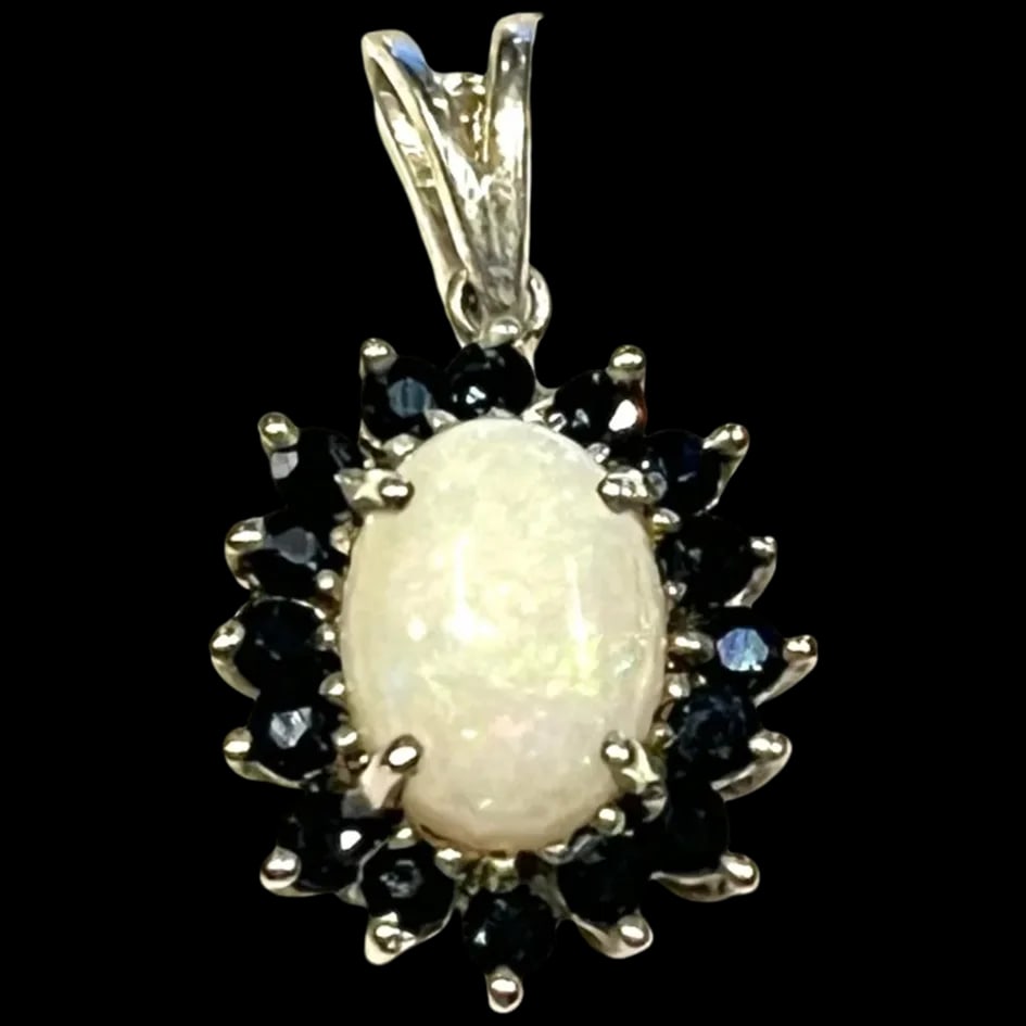 Estate Opal and Sapphire Sterling Silver Pendant: Title: Estate Opal and Sapphire Sterling Silver Pendant Description: Estate Opal and Sapphire Sterling Silver Pendant Hallmarked: 925 Weighs: 1.3 grams Measures: .75 x .50 inches Date/Period: Estate M