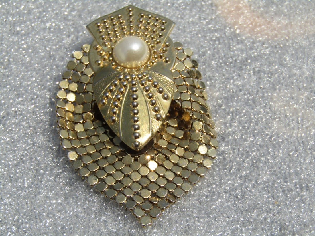 Vintage Mesh and Stamped Brooch, Art Deco Themed, 1980's, Faux Pearl: Vintage Mesh and Stamped Brooch, Art Deco Themed, 1980's, Faux Pearl. The brooch is a total of appx. 2.75" tall and 1.75" wide. The stamped piece sits over the draping mesh piece which does have movem