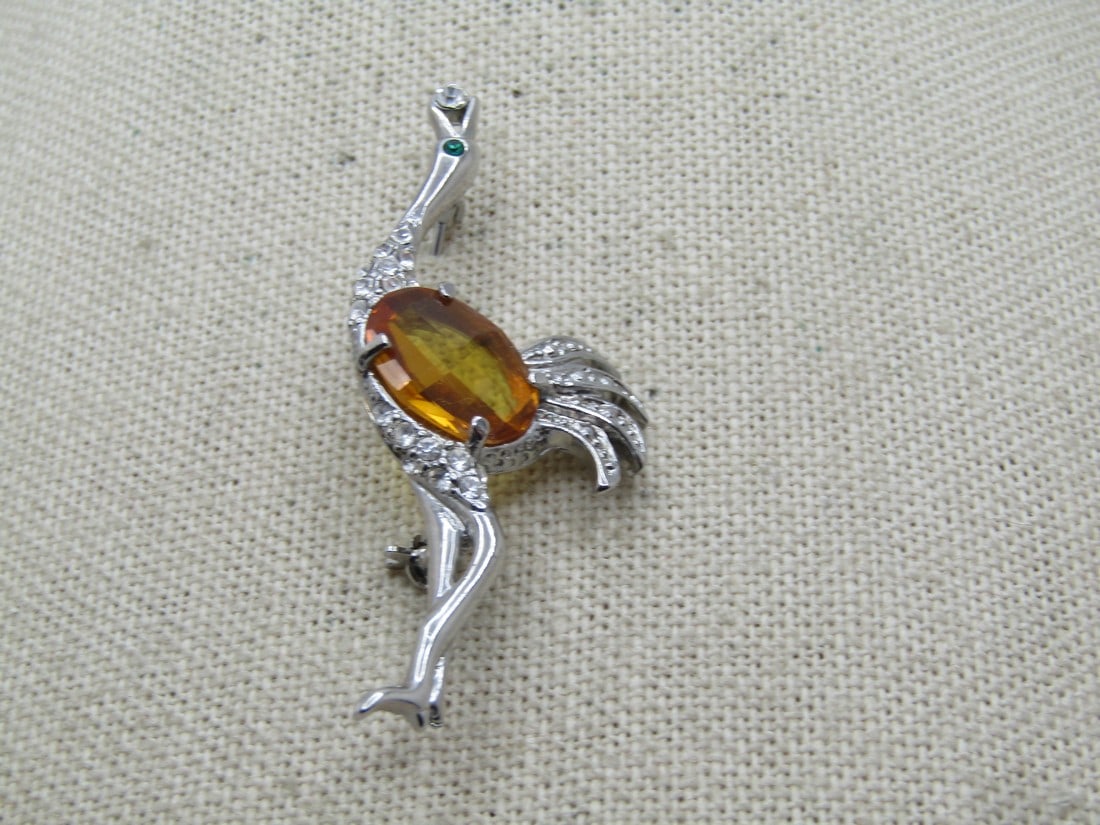 Vintage Yellow Stone Osterich Brooch, Clear Stones, 1960's,: Vintage Yellow Stone Osterich Brooch, Clear Stones, 1960's, It is silver tone, 2" tall and 1" wide with clear stones set in the neck and upper legs, illusion setting in the tail - no stones but the lo