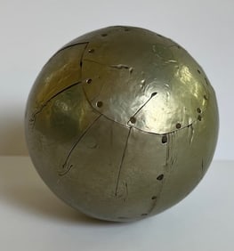 ARTSY, VINTAGE SPHERE COVERED IN HAND CUT SHEET OF STEEL FOIL TACKED IN PLACE