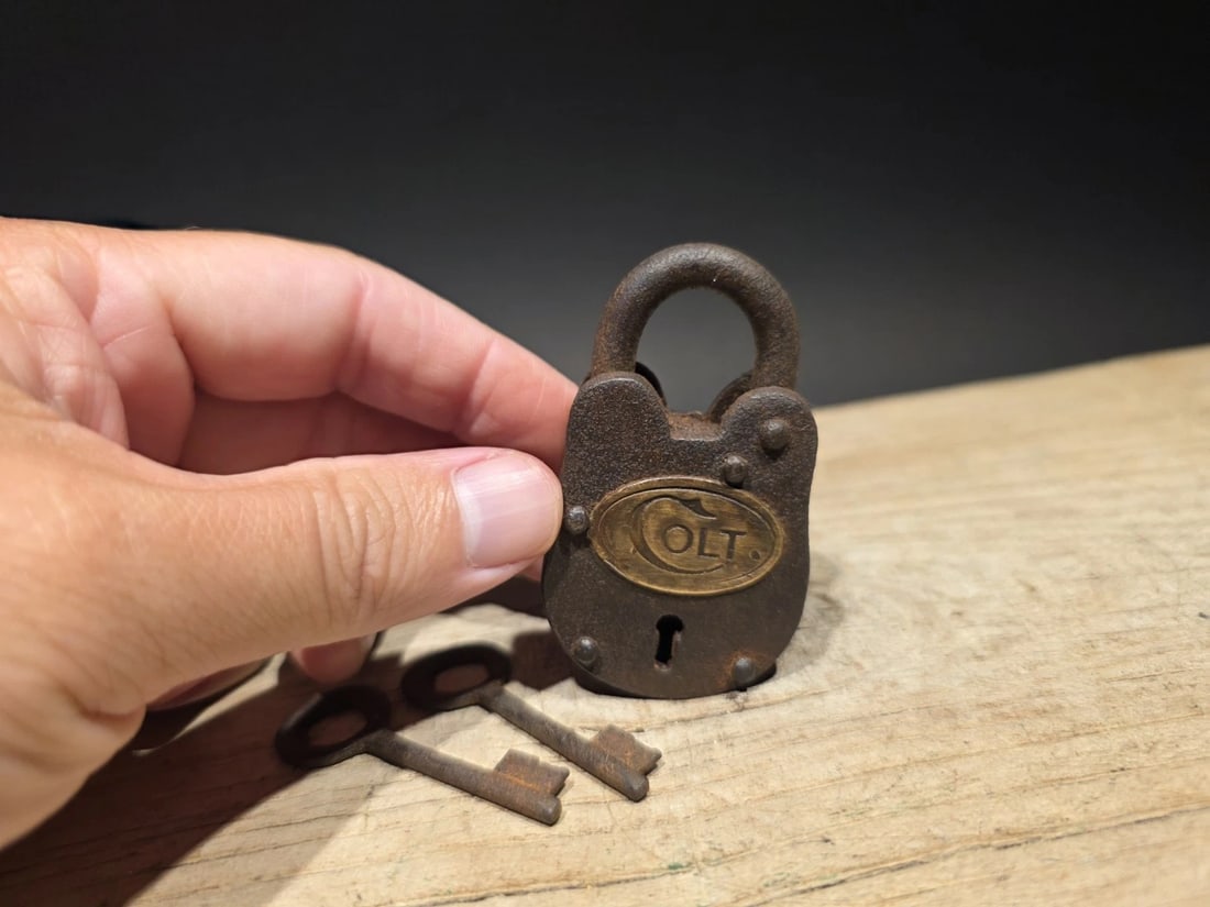 Cast Iron Colt Firearms Ammo Box Padlock Lock & Key: Nice reproduction cast iron Colt padlock! This lock is fully functional! Hard to tell its age. Heavy iron and brass. Great aged patina throughout. Limited quantity available! Reserve: $15.00 Shipping: