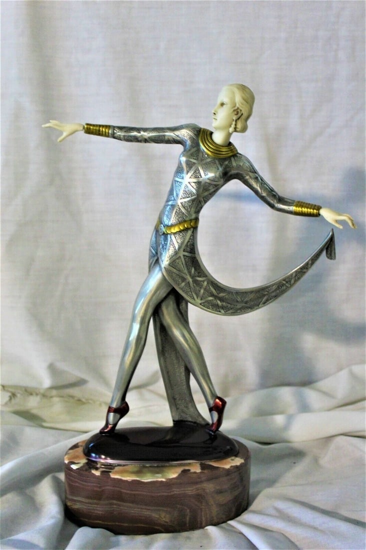 art deco dancer in the style of lorenzl ,cold cast ,pewter finish Ivorine , Mark: Great looking Art Deco Dancer . Hi-polished pewter body with hi-lights . Hands and face are of Ivorine . Bears the signature on the bottom by her feet ( Lorenzl ) Imported from England long ago . Very