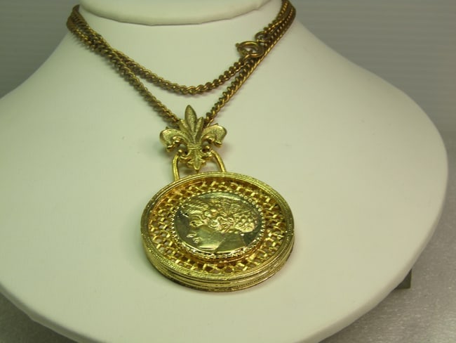 Vintage Greek/Roman Medallion Necklace, Fleur-De-Lis Bail, 24", 1960's: Vintage Roman or Greecian Medallion Necklace, Fleur-De-Lis Bail, 24", 1960's. This has a Roman or Grecian Head in the center over an open woven background with textured raised finish on the edge. It i